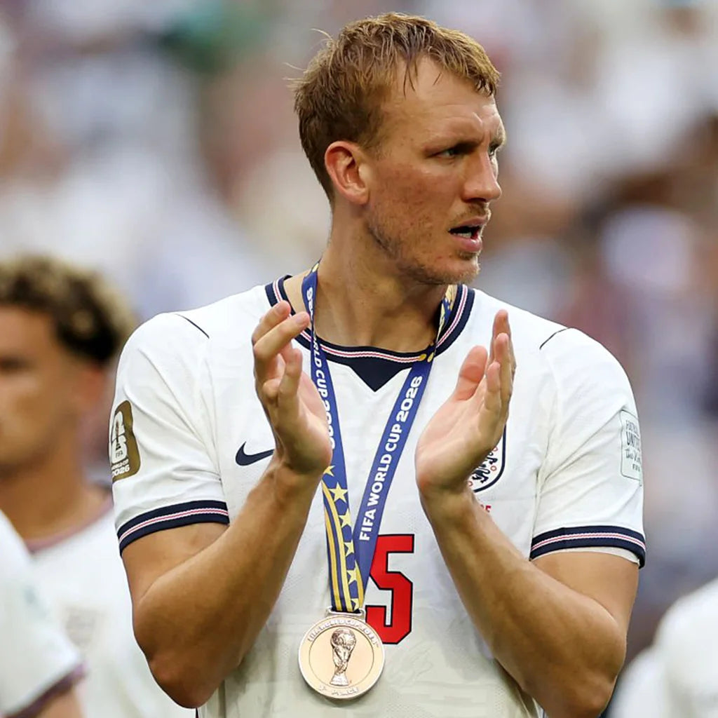 England players lift their bronze medals after winning the World Cup third-place match