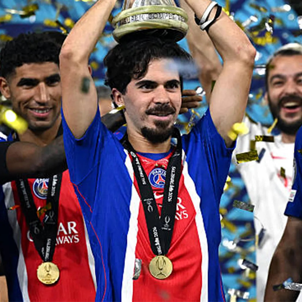 Man in PSG jersey holding gold Super Cup 2026 medal