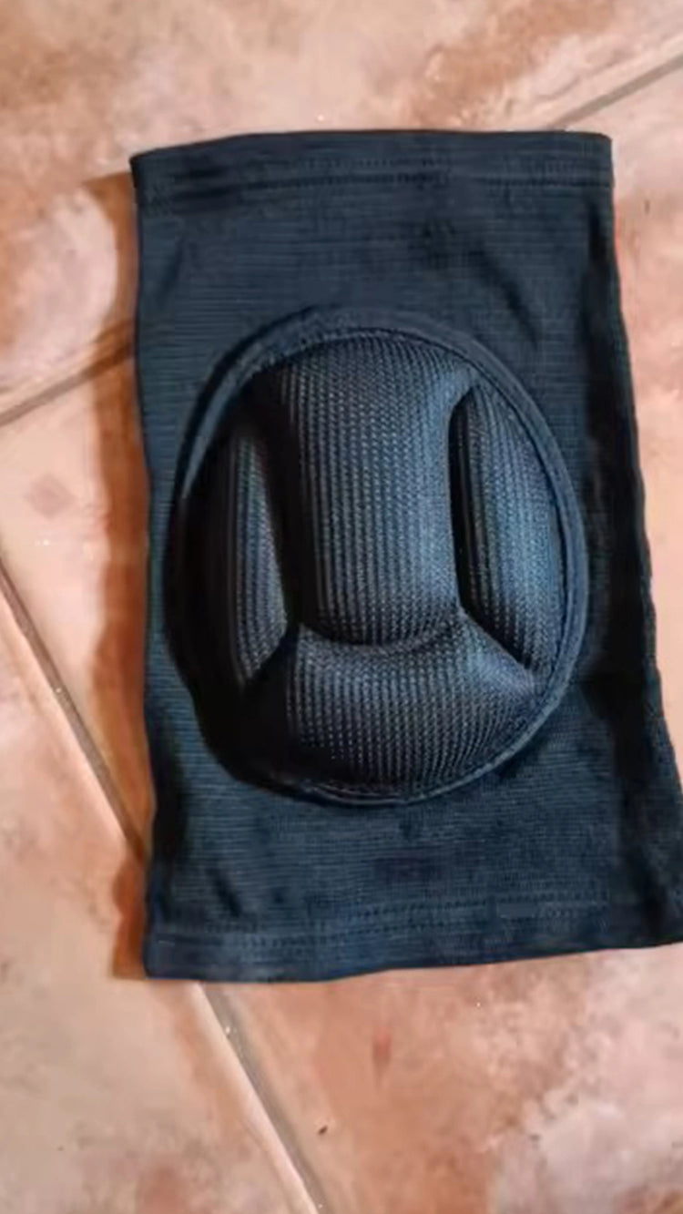 Black knee pad on a brown surface