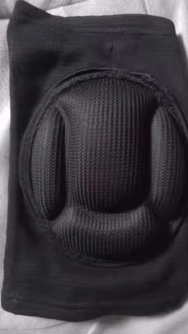 Black knee pad on a textured surface