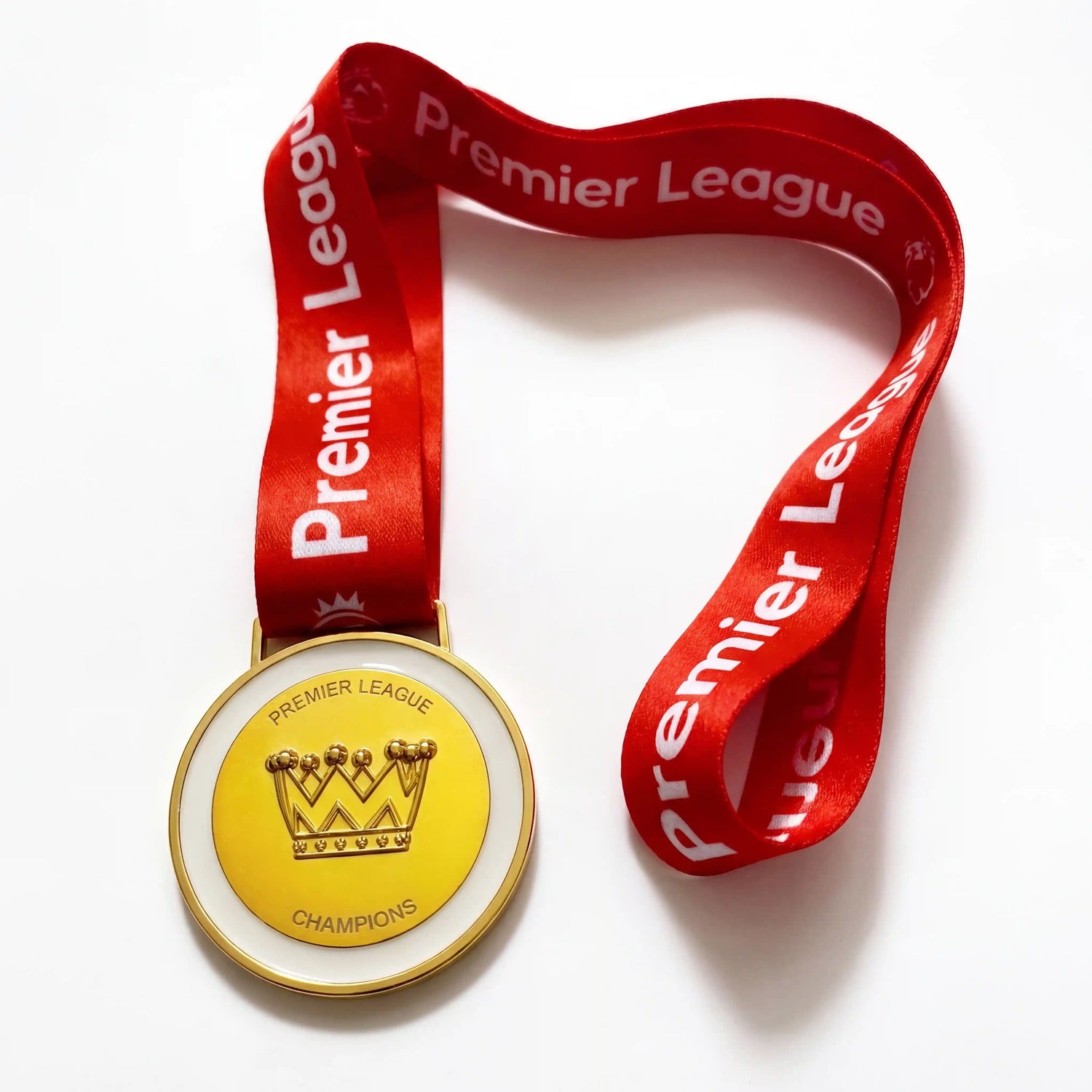 Close view of Arsenal fan medal inspired by Premier League trophy win