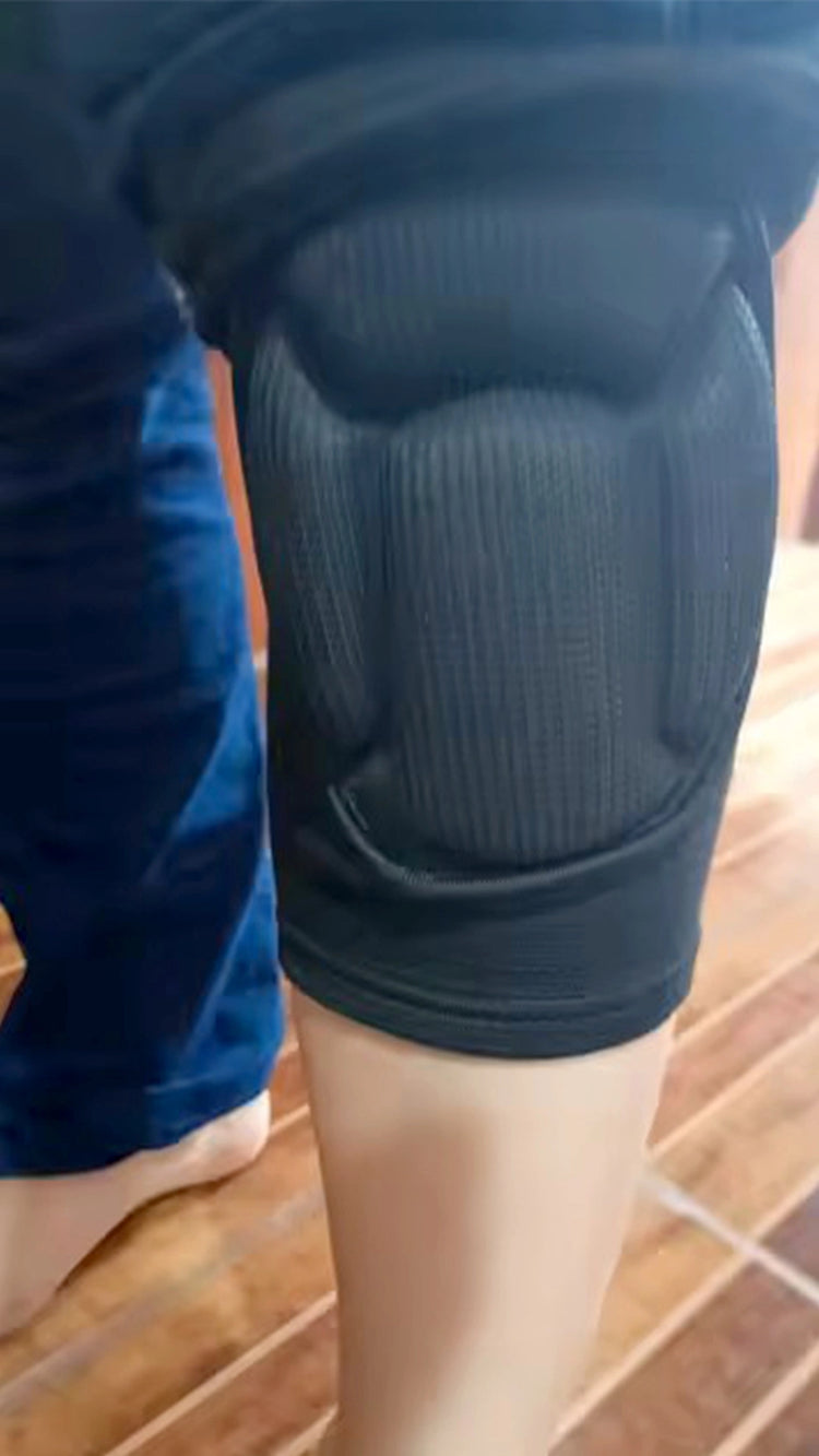 Person wearing a black knee pad on a wooden floor