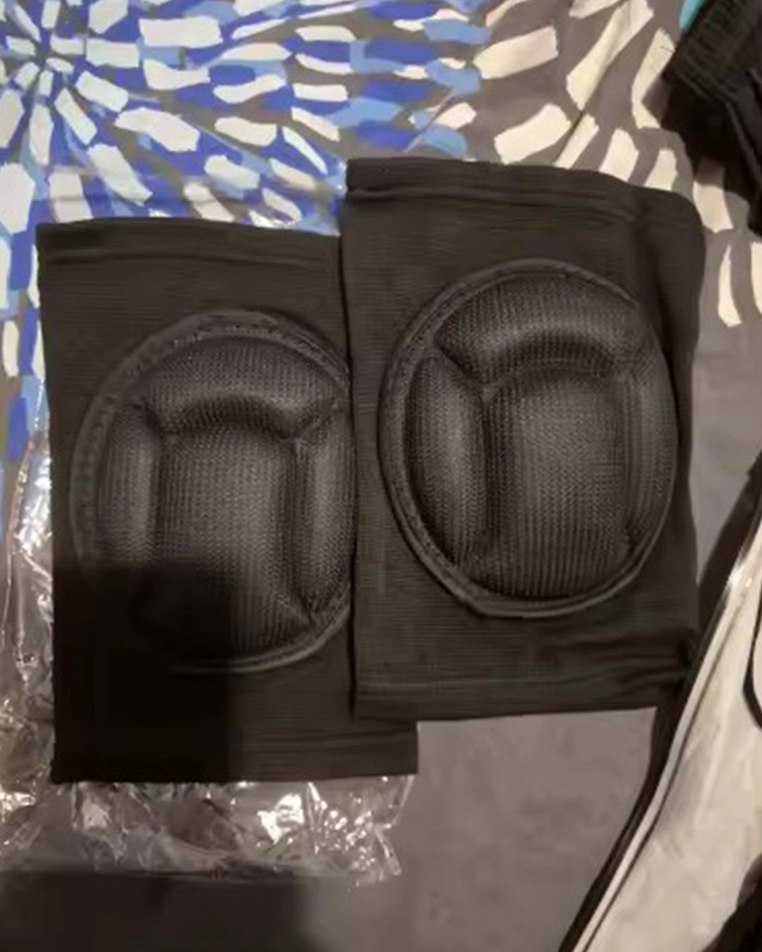 Black knee pads on a patterned surface