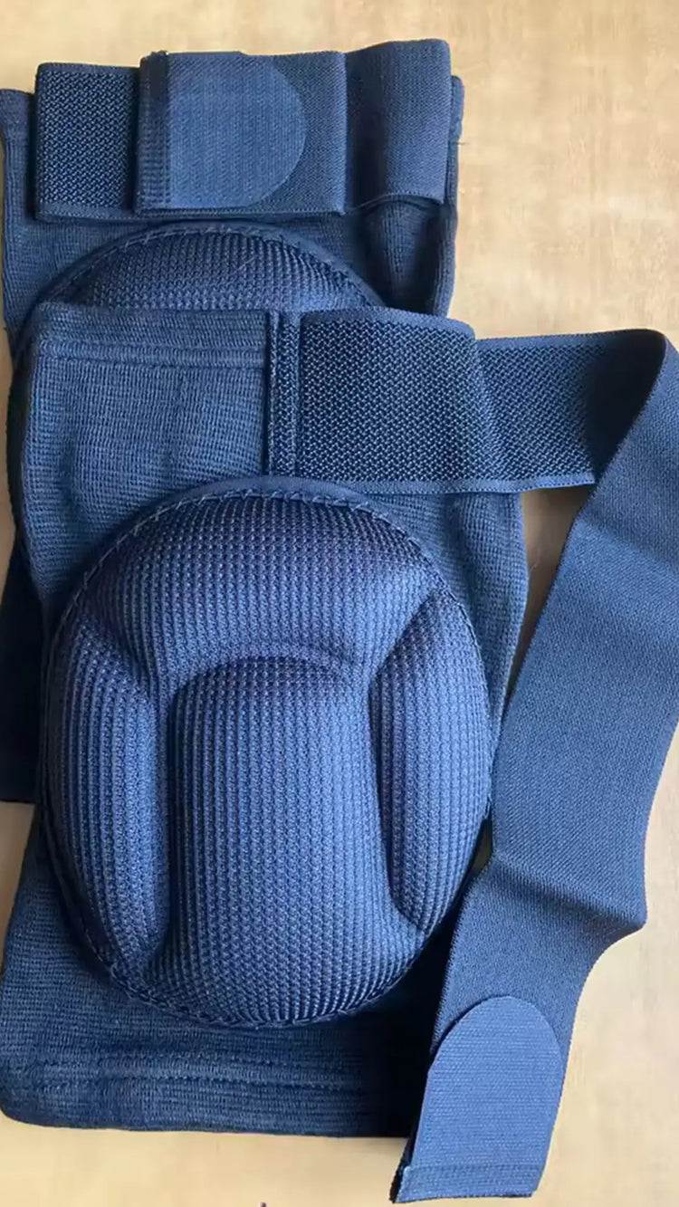 Blue knee pad with a strap on a beige background