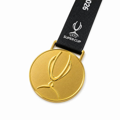 Football fan wearing PSG Super Cup 2026 gold medal around neck